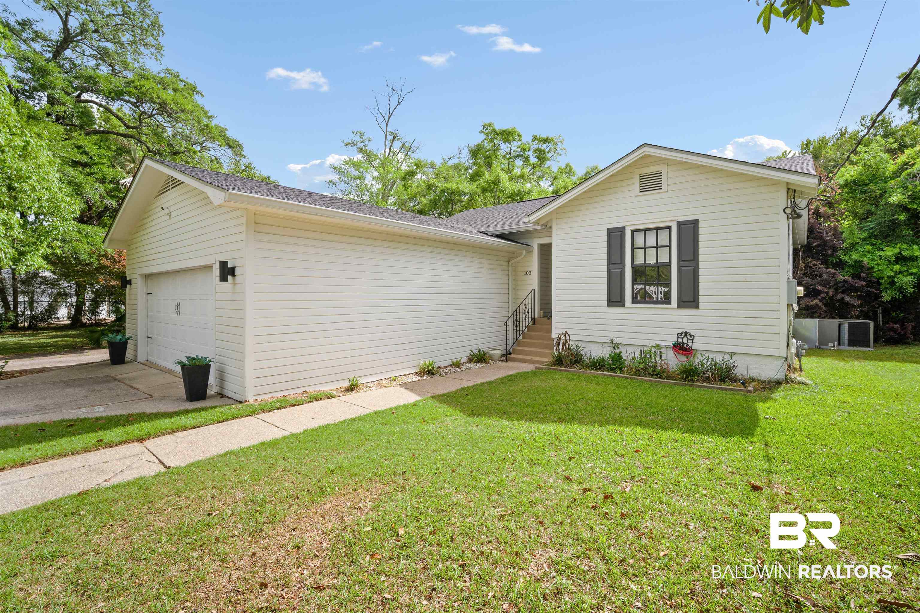 103 Emogene Place Mobile, AL 36606 - Photo 5 of 32 Single story home featuring a front yard, an attached garage, roof with shingles, and concrete driveway