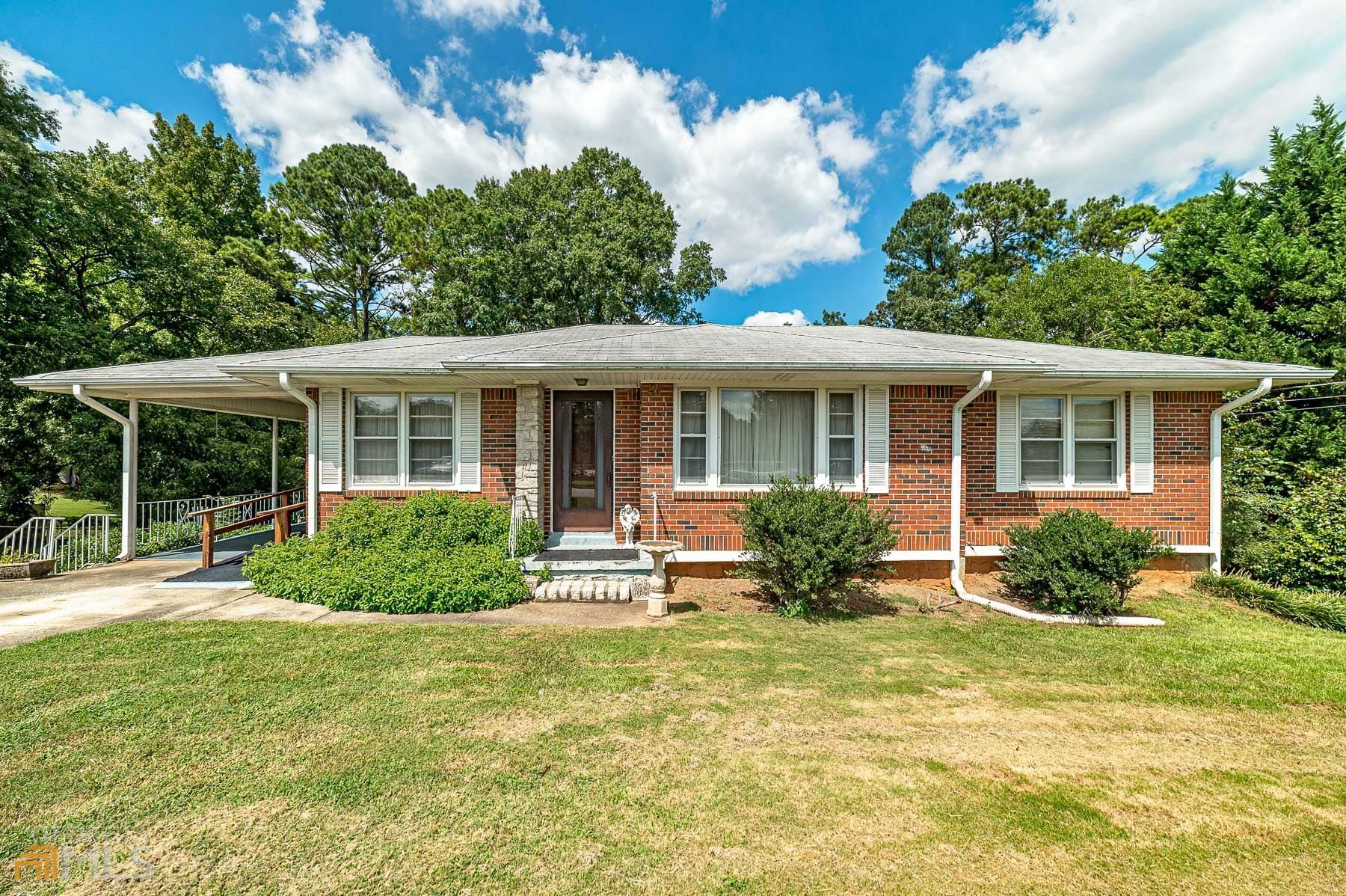 1068 Tanglewood Road Jonesboro, GA 30236 - Photo 1 of 1 a front view of house with yard and green space