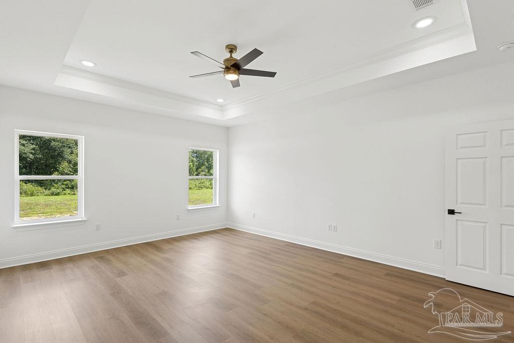 638 Ard Field Road Jay, FL 32565 - Photo 13 of 39 an empty room with wooden floor fan and windows