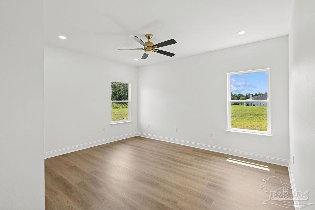 638 Ard Field Road Jay, FL 32565 - Photo 25 of 39 a view of an empty room with a window and wooden floor