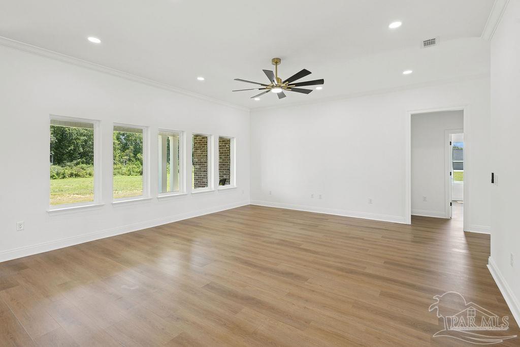 638 Ard Field Road Jay, FL 32565 - Photo 10 of 39 a view of an empty room with a window and a kitchen