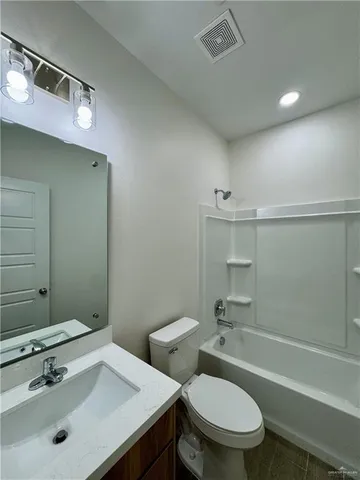 a bathroom with a sink mirror toilet and bathtub