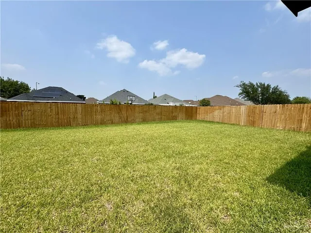 a view of an house with swimming pool and a yard