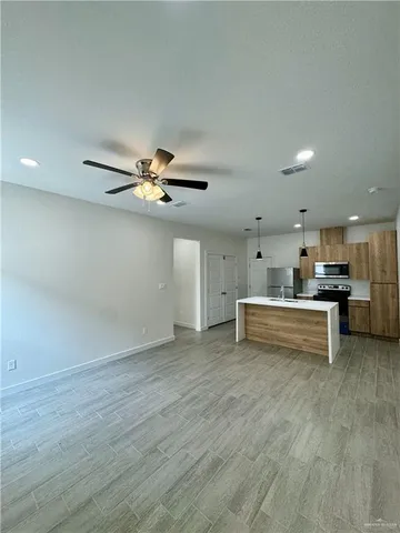 a view of a kitchen with a sink and cabinets