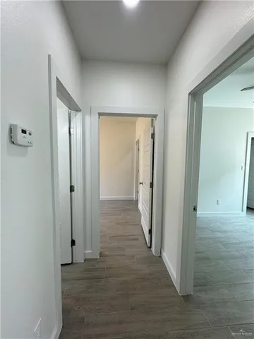 a view of a hallway with wooden floor