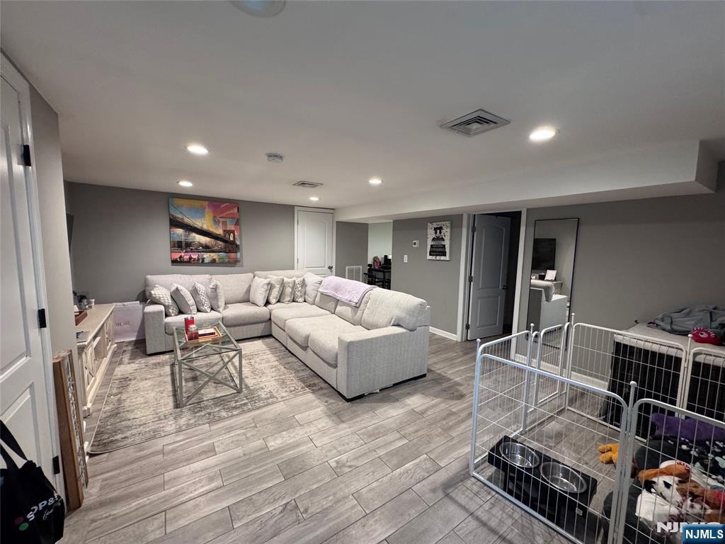 126 Riverside Avenue, Unit 1 Lyndhurst, NJ 07071 - Photo 2 of 10 a living room with furniture and wooden floor