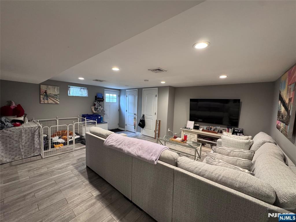 126 Riverside Avenue, Unit 1 Lyndhurst, NJ 07071 - Photo 3 of 10 a living room with furniture and a flat screen tv