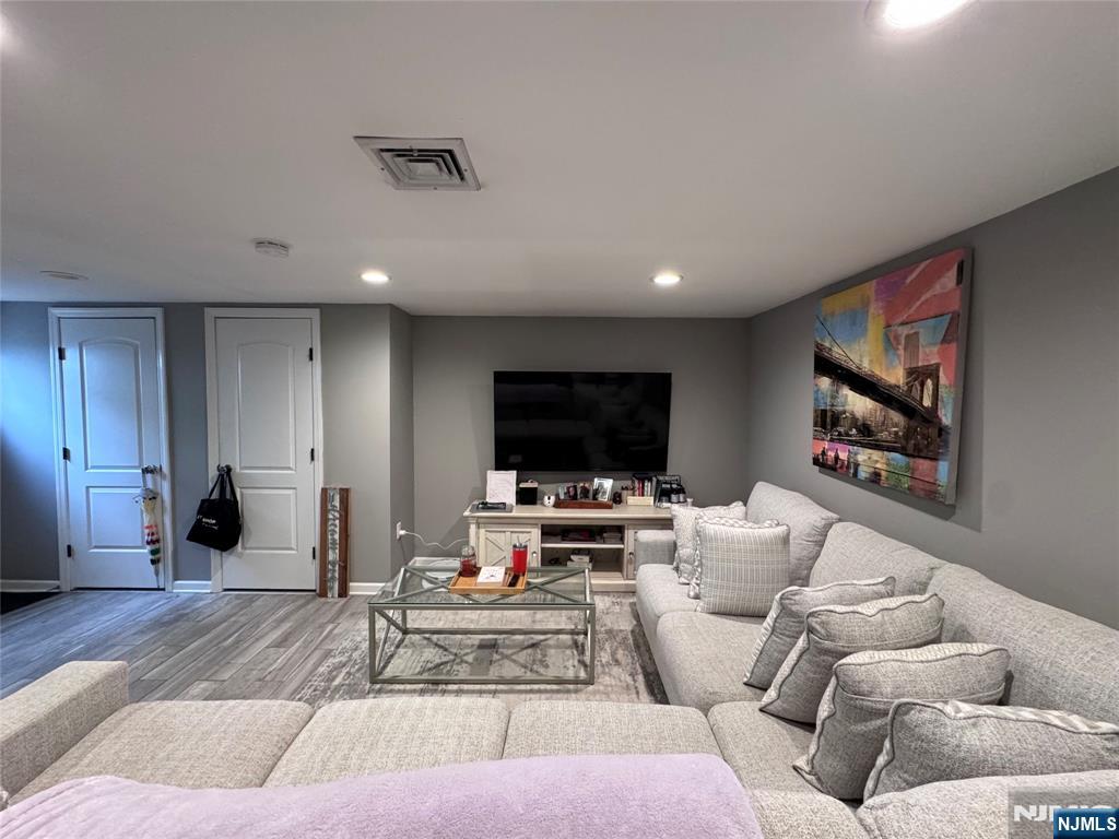 126 Riverside Avenue, Unit 1 Lyndhurst, NJ 07071 - Photo 4 of 10 a living room with furniture and a flat screen tv