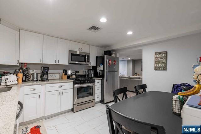 126 Riverside Avenue, Unit 1 Lyndhurst, NJ 07071 - Photo 6 of 10 a kitchen with granite countertop a sink appliances and cabinets