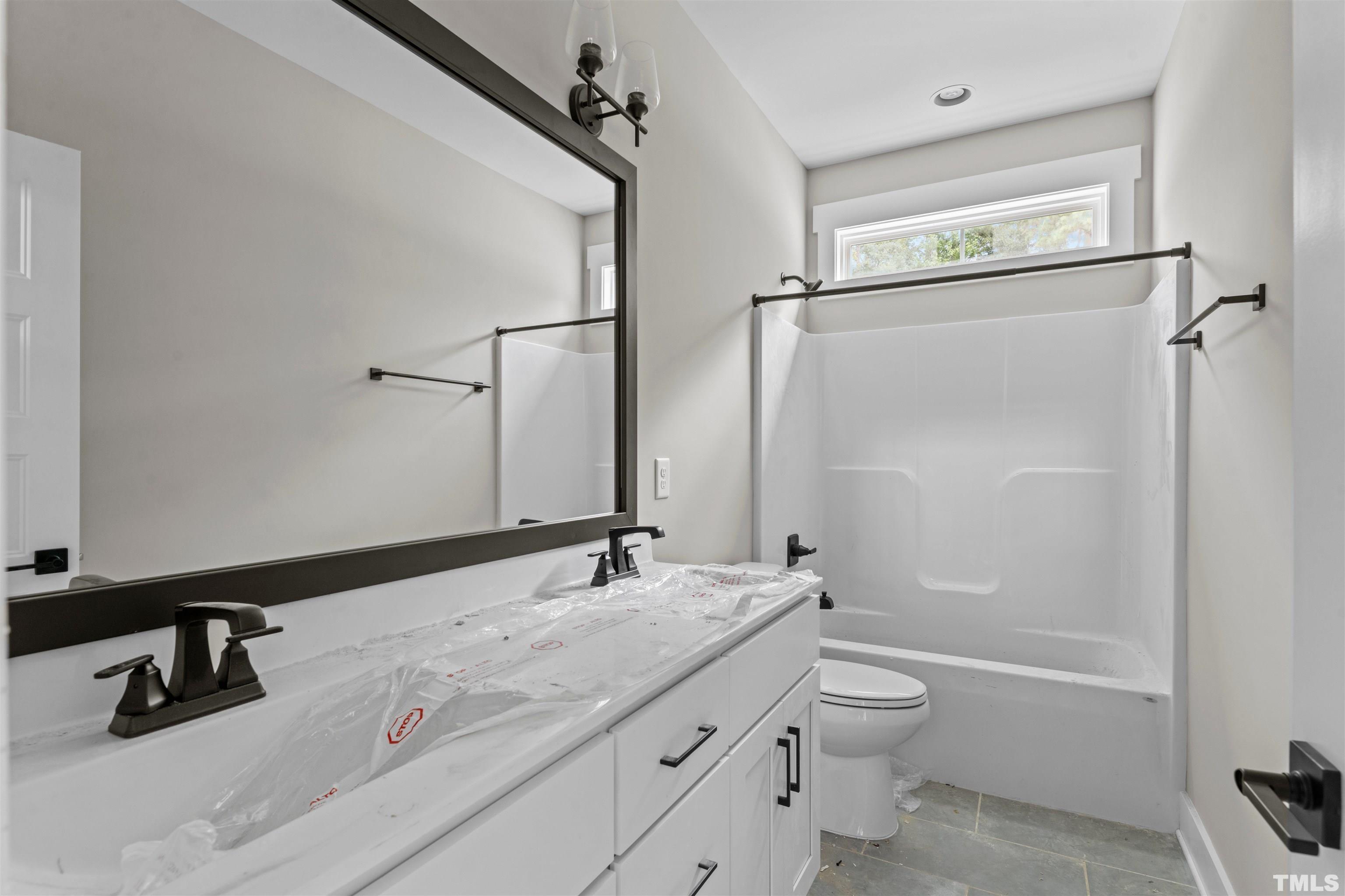 97 Buckstone Place Willow Spring, NC 27592 - Photo 12 of 21 a bathroom with a granite countertop sink toilet and shower