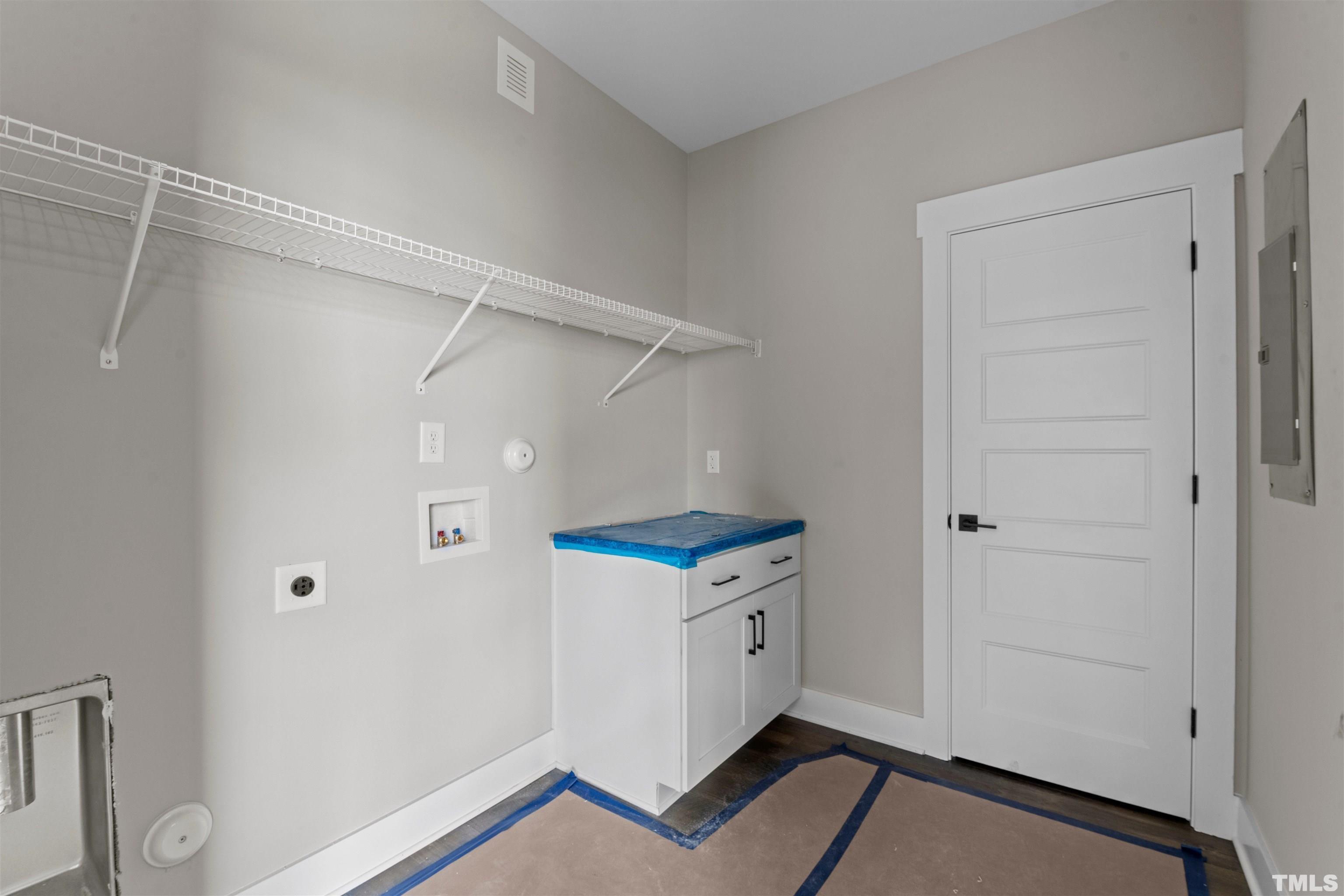 97 Buckstone Place Willow Spring, NC 27592 - Photo 14 of 21 a kitchen with white cabinets and white appliances