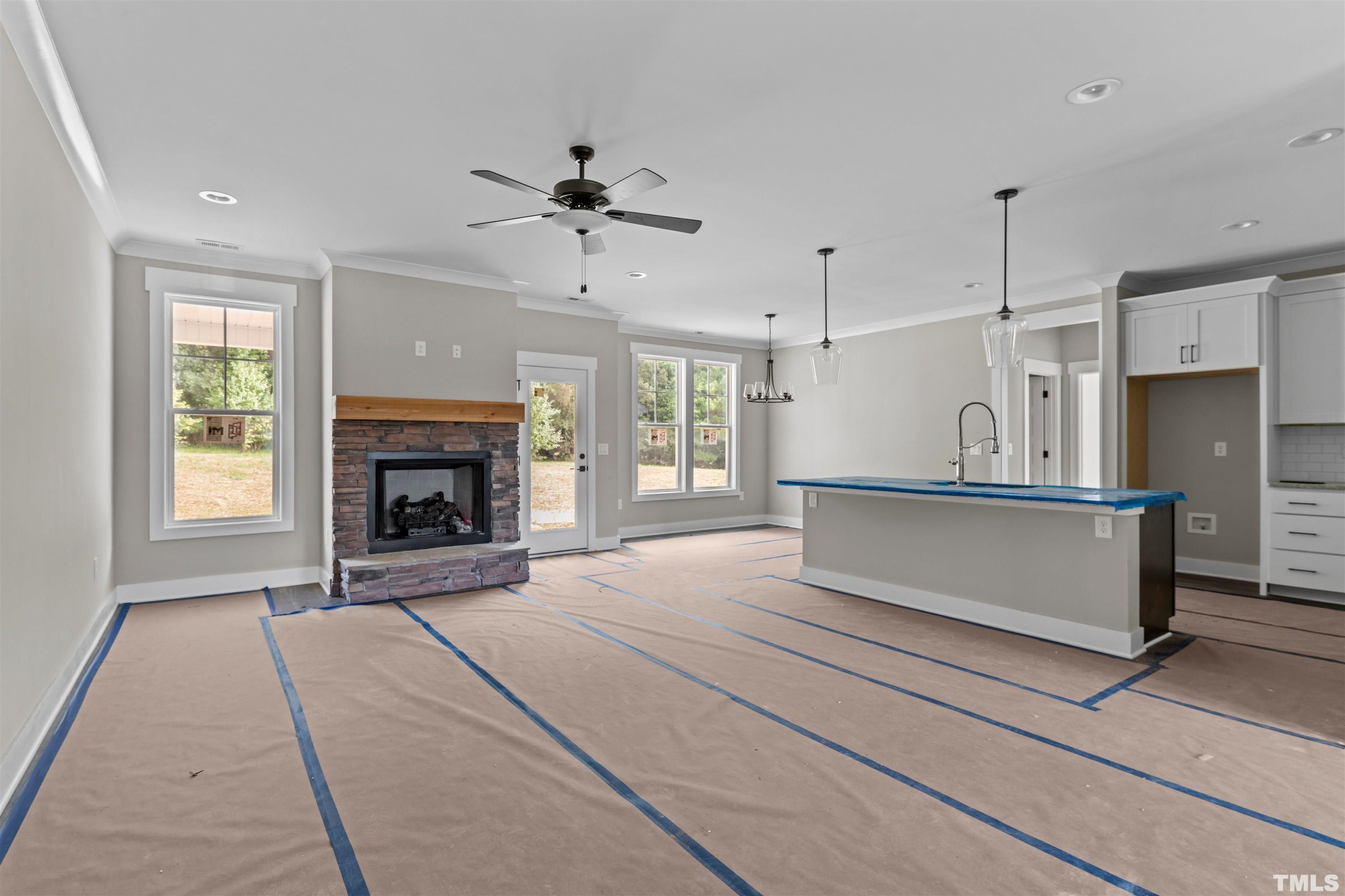 97 Buckstone Place Willow Spring, NC 27592 - Photo 16 of 21 a view of an empty room with a fireplace and a window