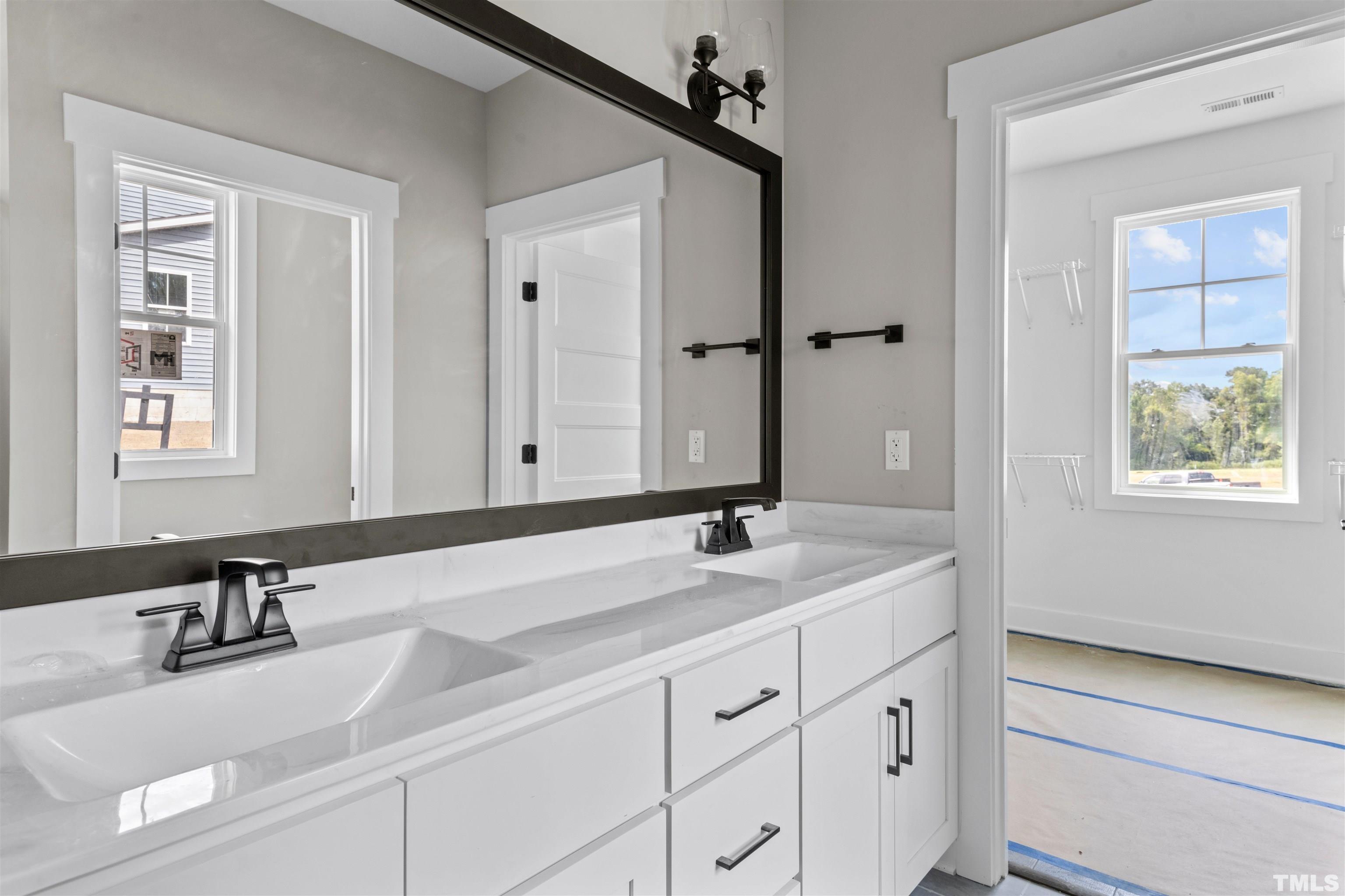 97 Buckstone Place Willow Spring, NC 27592 - Photo 18 of 21 a bathroom with a sink and a mirror