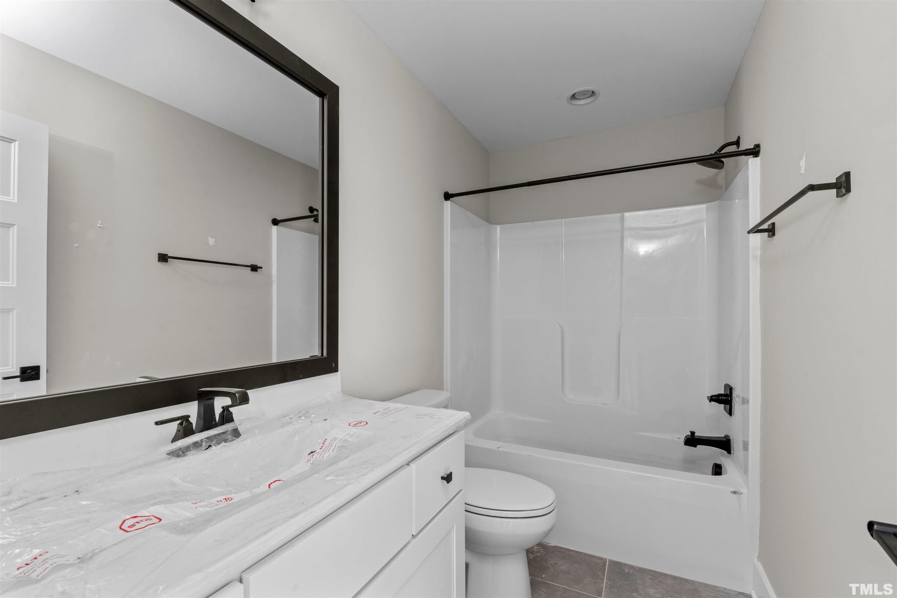 97 Buckstone Place Willow Spring, NC 27592 - Photo 21 of 21 a bathroom with a granite countertop sink toilet and shower
