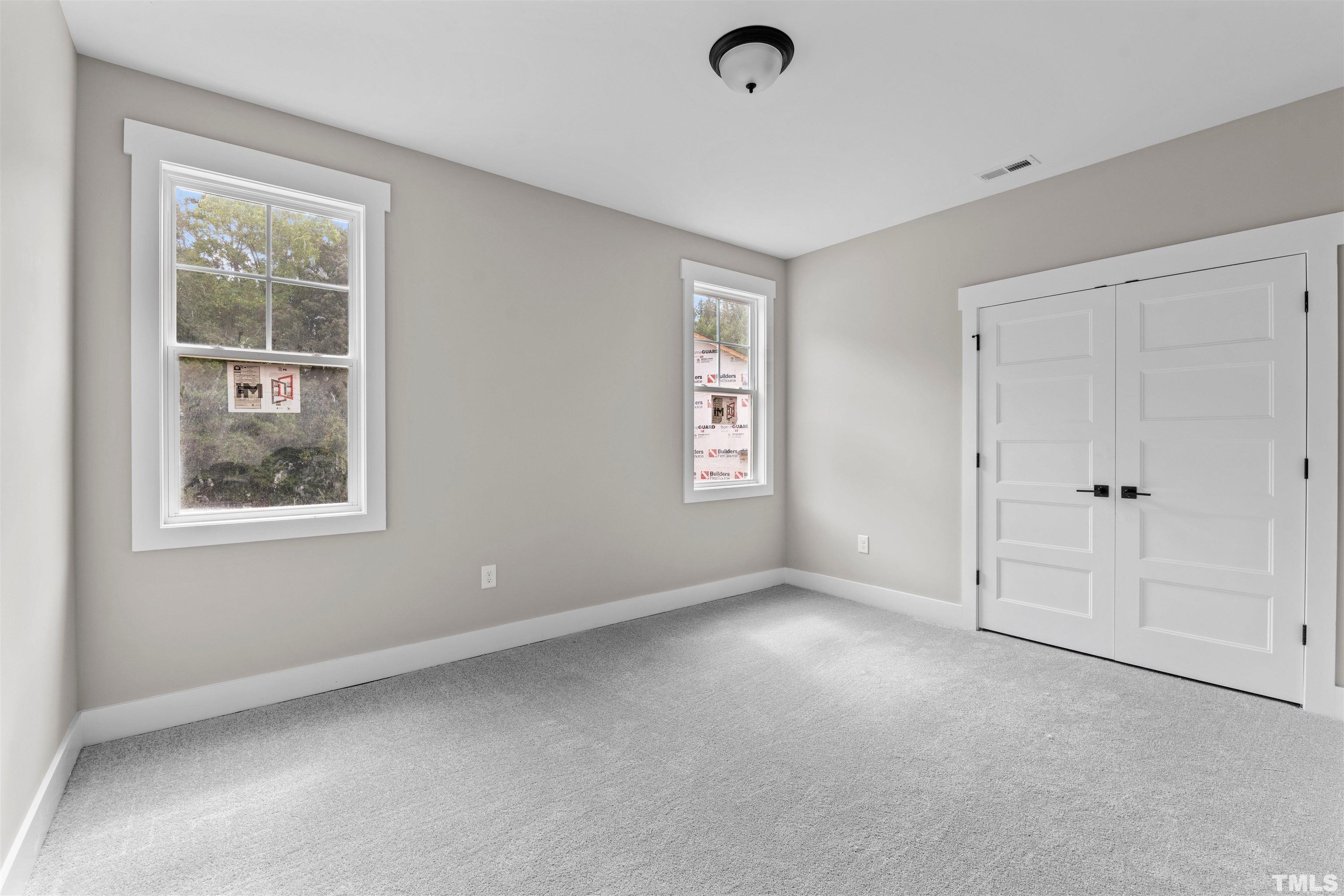 97 Buckstone Place Willow Spring, NC 27592 - Photo 5 of 21 an empty room with windows