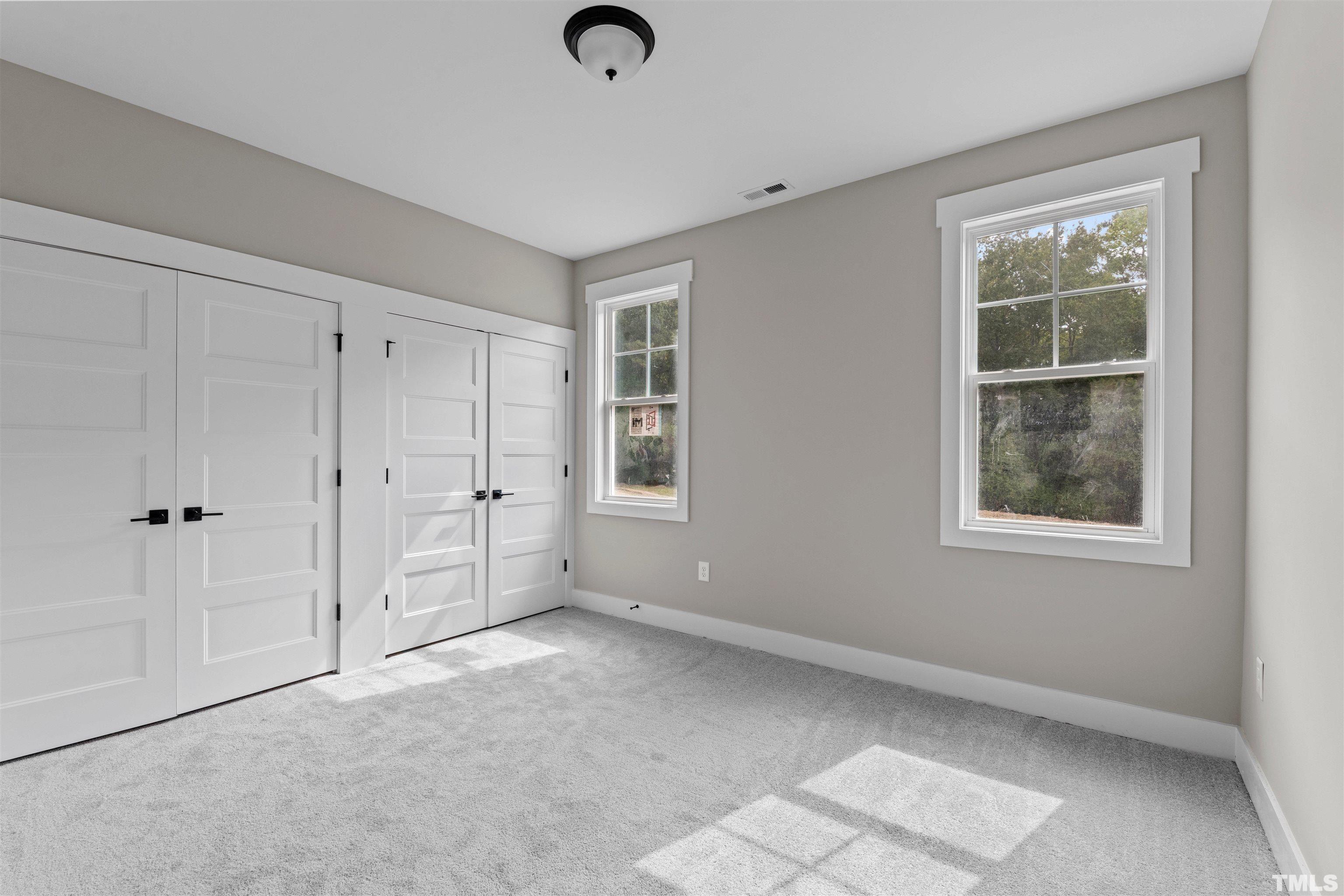 97 Buckstone Place Willow Spring, NC 27592 - Photo 6 of 21 an empty room with windows