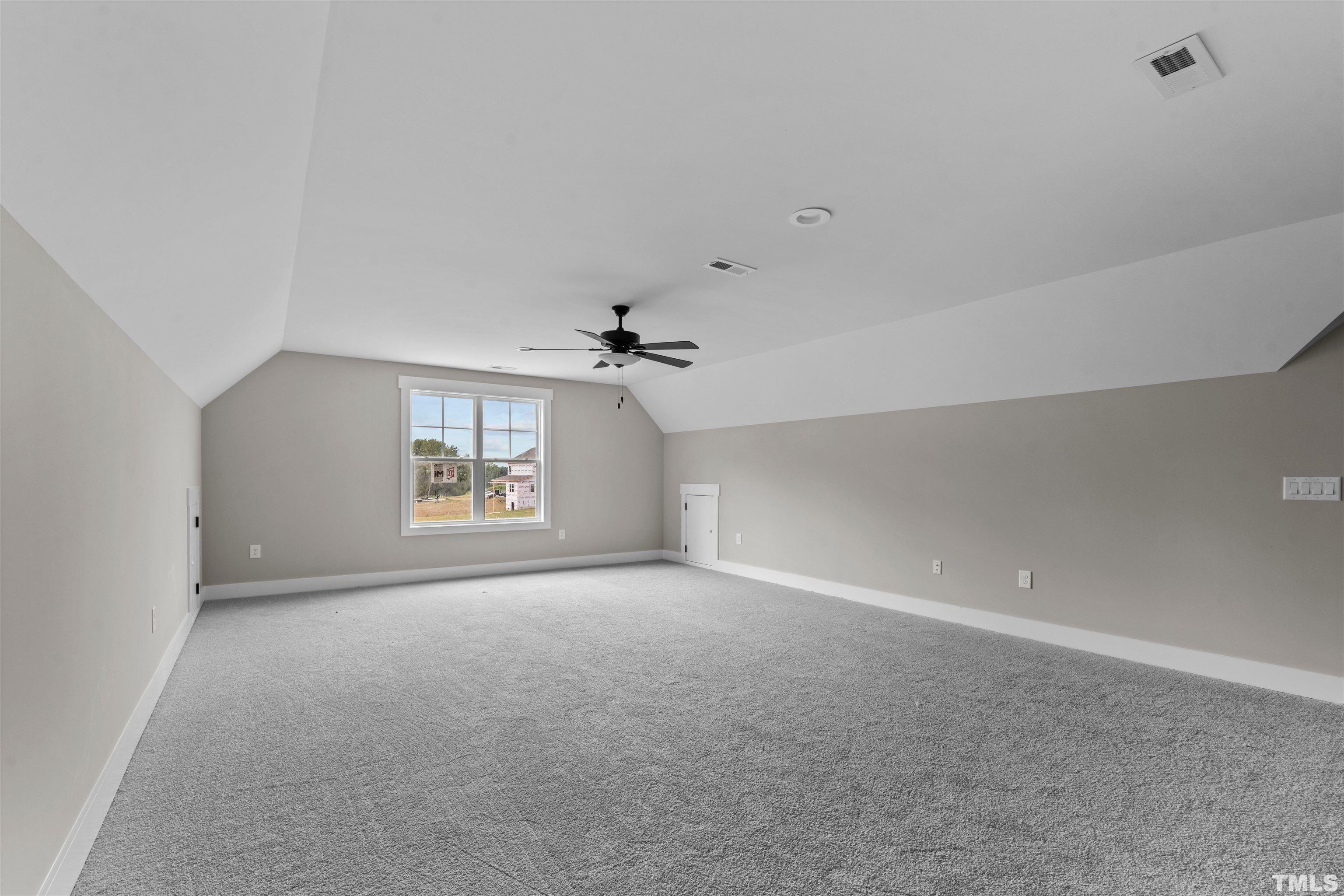 97 Buckstone Place Willow Spring, NC 27592 - Photo 7 of 21 a view of a big room with windows and chandelier fan