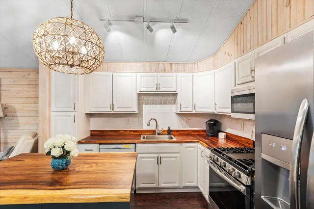 a kitchen with stainless steel appliances granite countertop a sink and cabinets