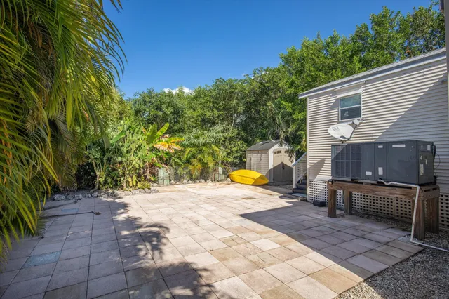a view of a backyard with sitting area