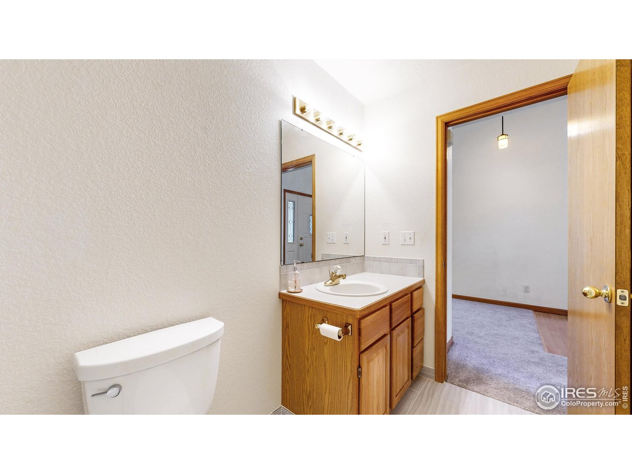 711 Eagle Lane Estes Park, CO 80517 - Photo 12 of 20 a bathroom with a sink a toilet and mirror