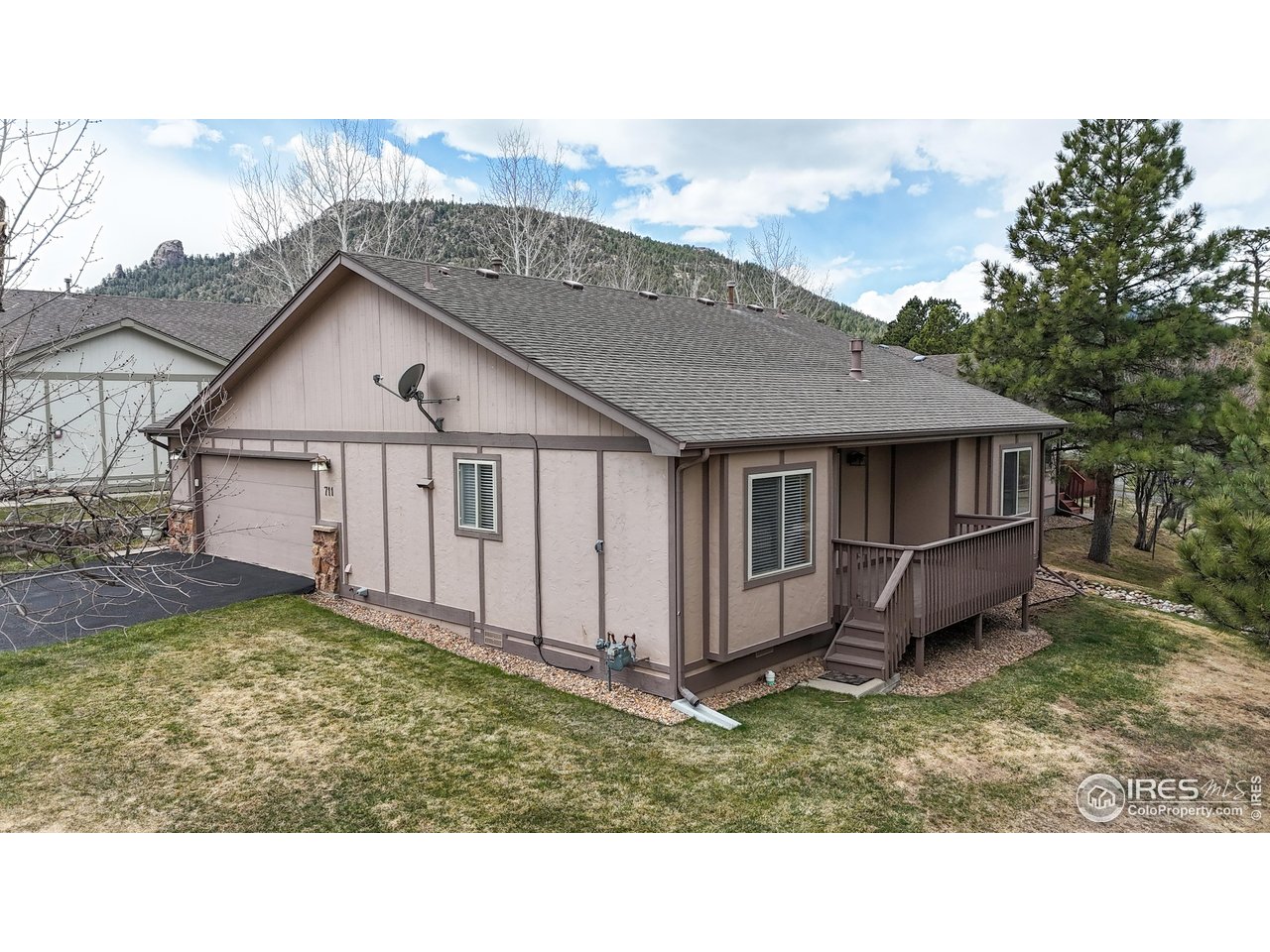 711 Eagle Lane Estes Park, CO 80517 - Photo 17 of 20 a view of a house with a wooden deck and a yard