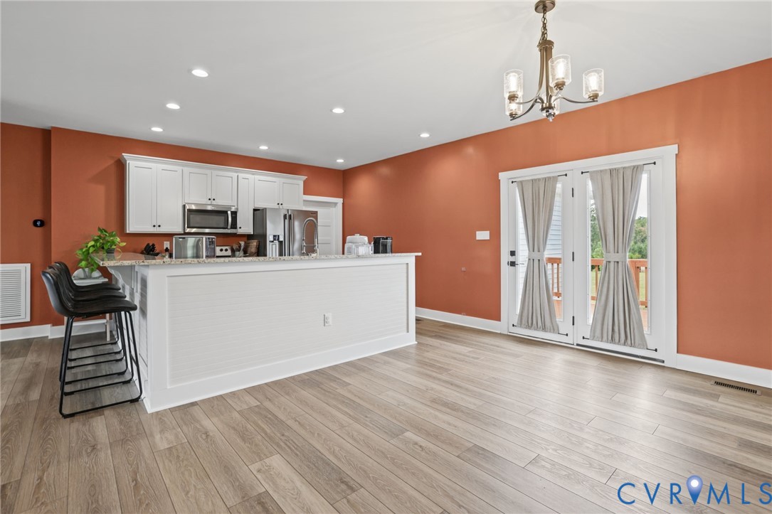 115 Jenkins Church Road Cumberland, VA 23040 - Photo 6 of 28 Kitchen featuring white cabinetry, light-toned woo