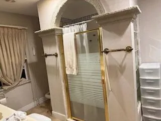 a bathroom with a shower and a toilet