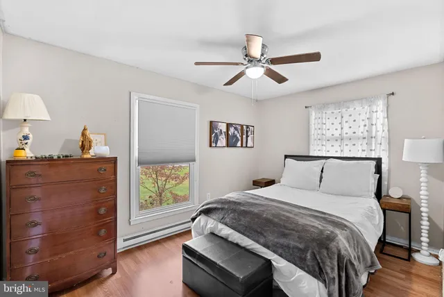 a bedroom with a large bed and a window