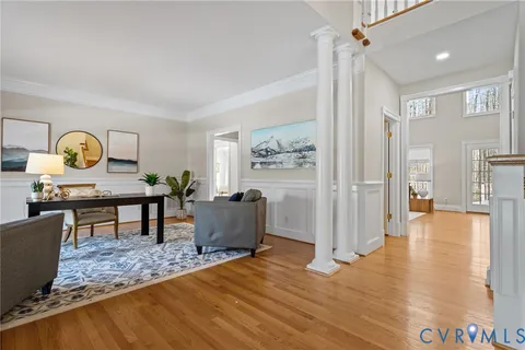 a living room with furniture and wooden floor