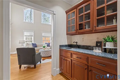 a living room with granite countertop furniture a rug and wooden floor