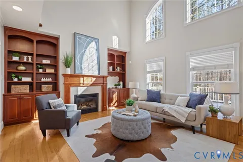 a living room with furniture fireplace and a large window
