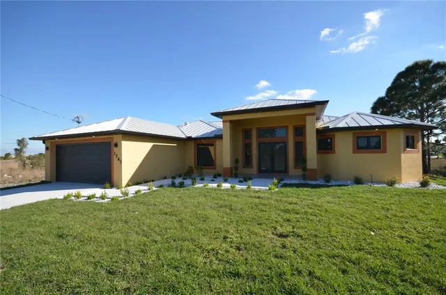a view of a house with a yard and sitting area