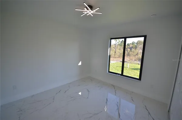 an empty room with windows and closet