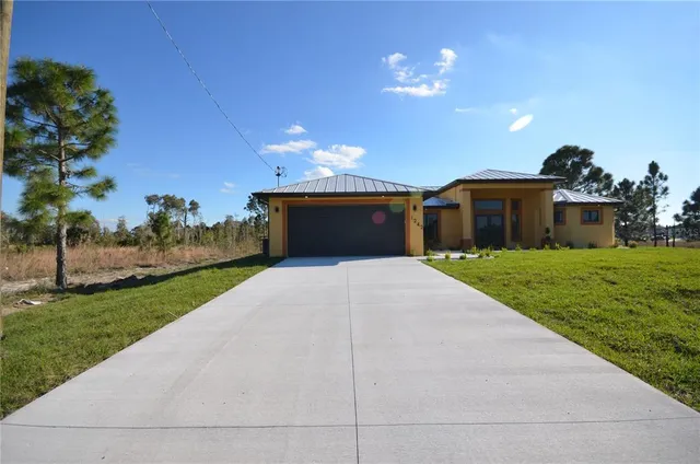 a front view of house with yard and green space