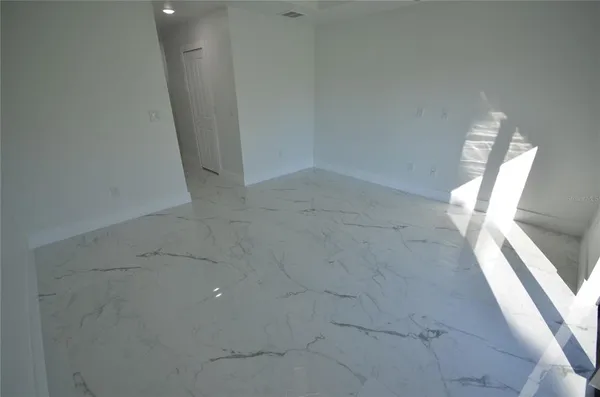 an empty room with a ceiling fan