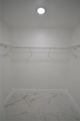 a bathroom with double sink a mirror and shower