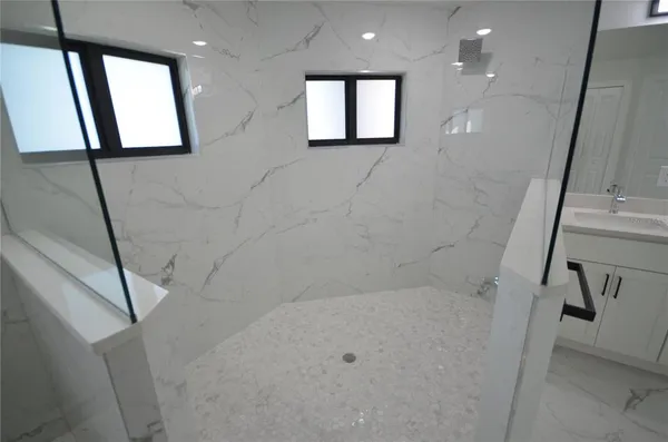 a spacious bathroom with a double vanity sink a mirror and a bathtub
