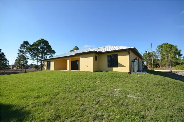 a view of a house with yard and a garden
