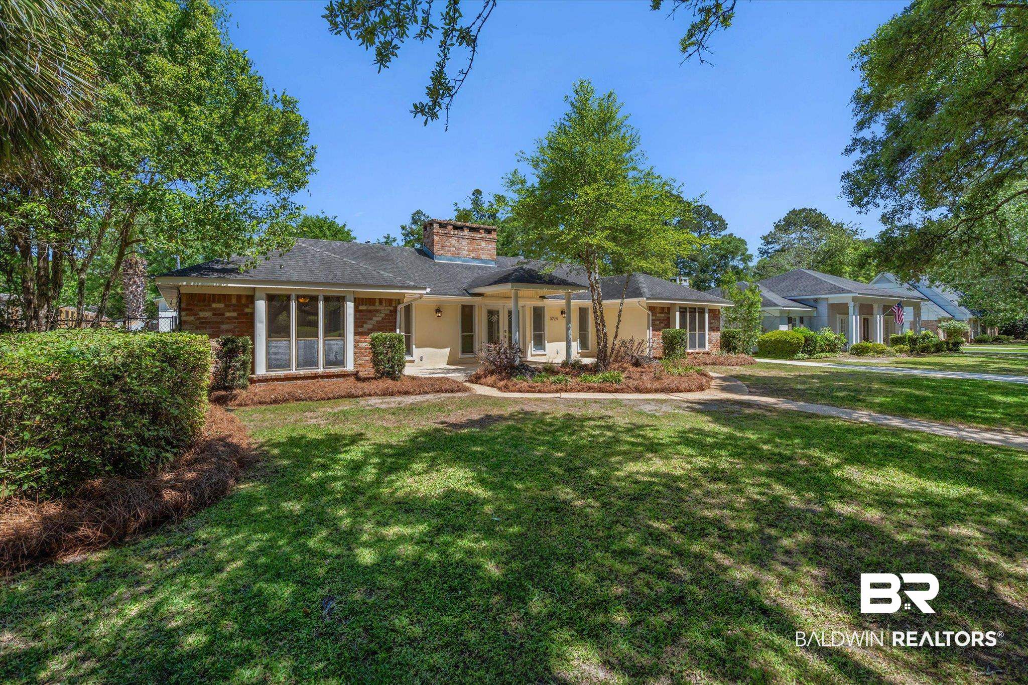 3724 Claridge Road South Mobile, AL 36608 - Photo 41 of 42 View of front facade featuring brick siding, a front yard, a porch, and a chimney