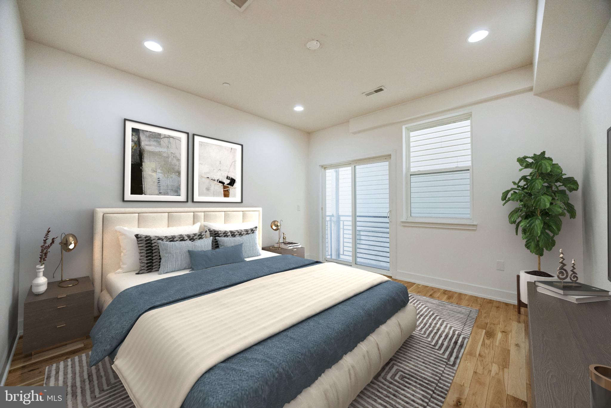 614 Master Street, Unit 2 Philadelphia, PA 19122 - Photo 12 of 29 a bedroom with a large bed and a potted plant