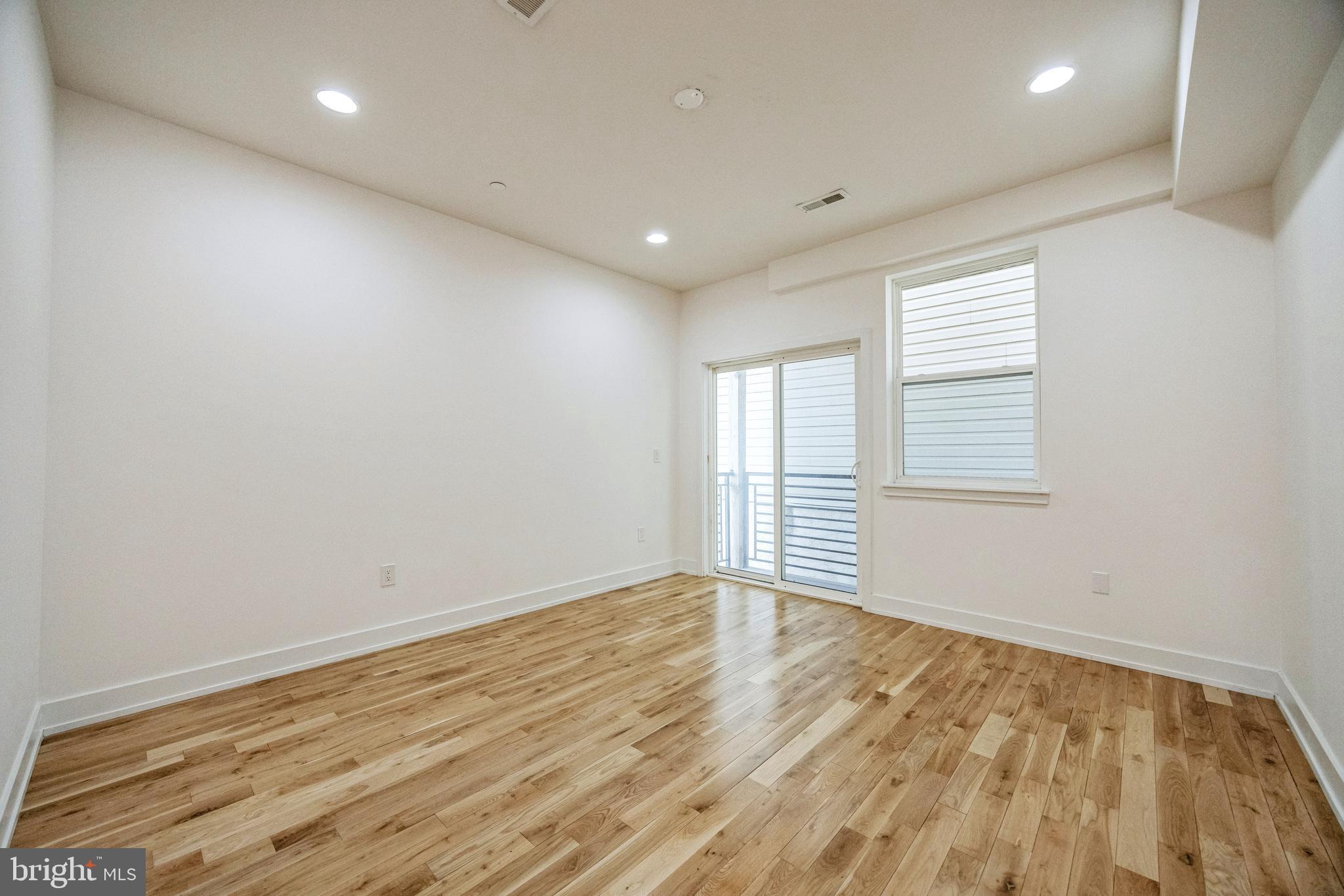 614 Master Street, Unit 2 Philadelphia, PA 19122 - Photo 13 of 29 wooden floor in an empty room with a window