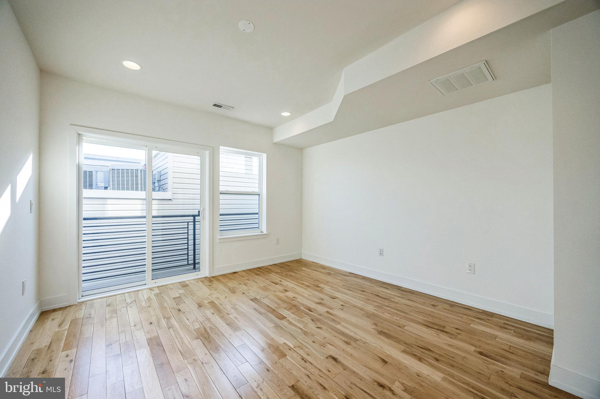 614 Master Street, Unit 2 Philadelphia, PA 19122 - Photo 14 of 29 wooden floor in an empty room with a window