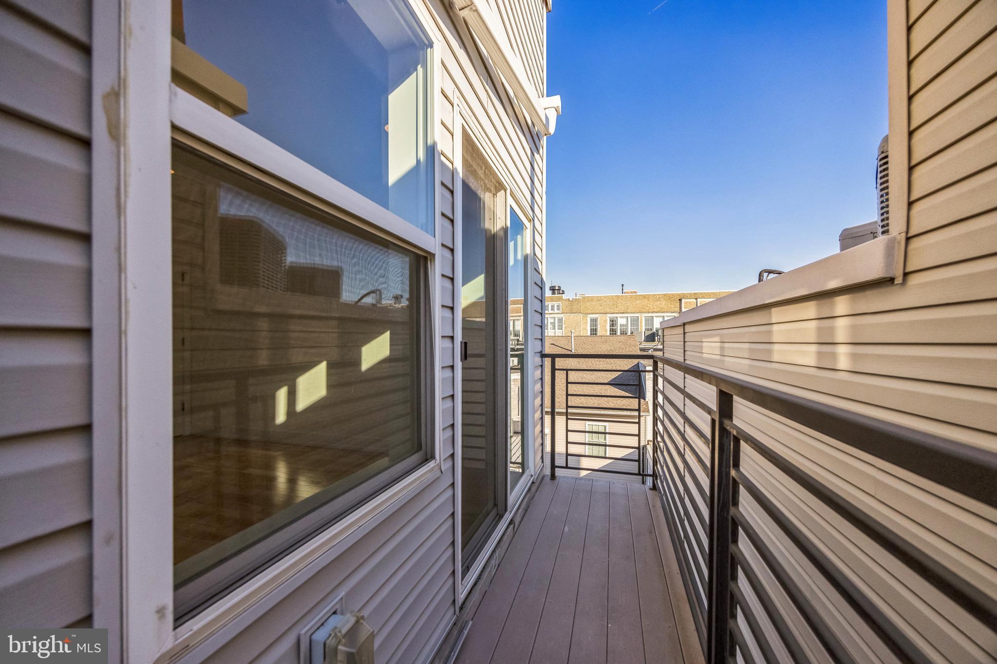 614 Master Street, Unit 2 Philadelphia, PA 19122 - Photo 16 of 29 a view of a balcony with wooden floor and door