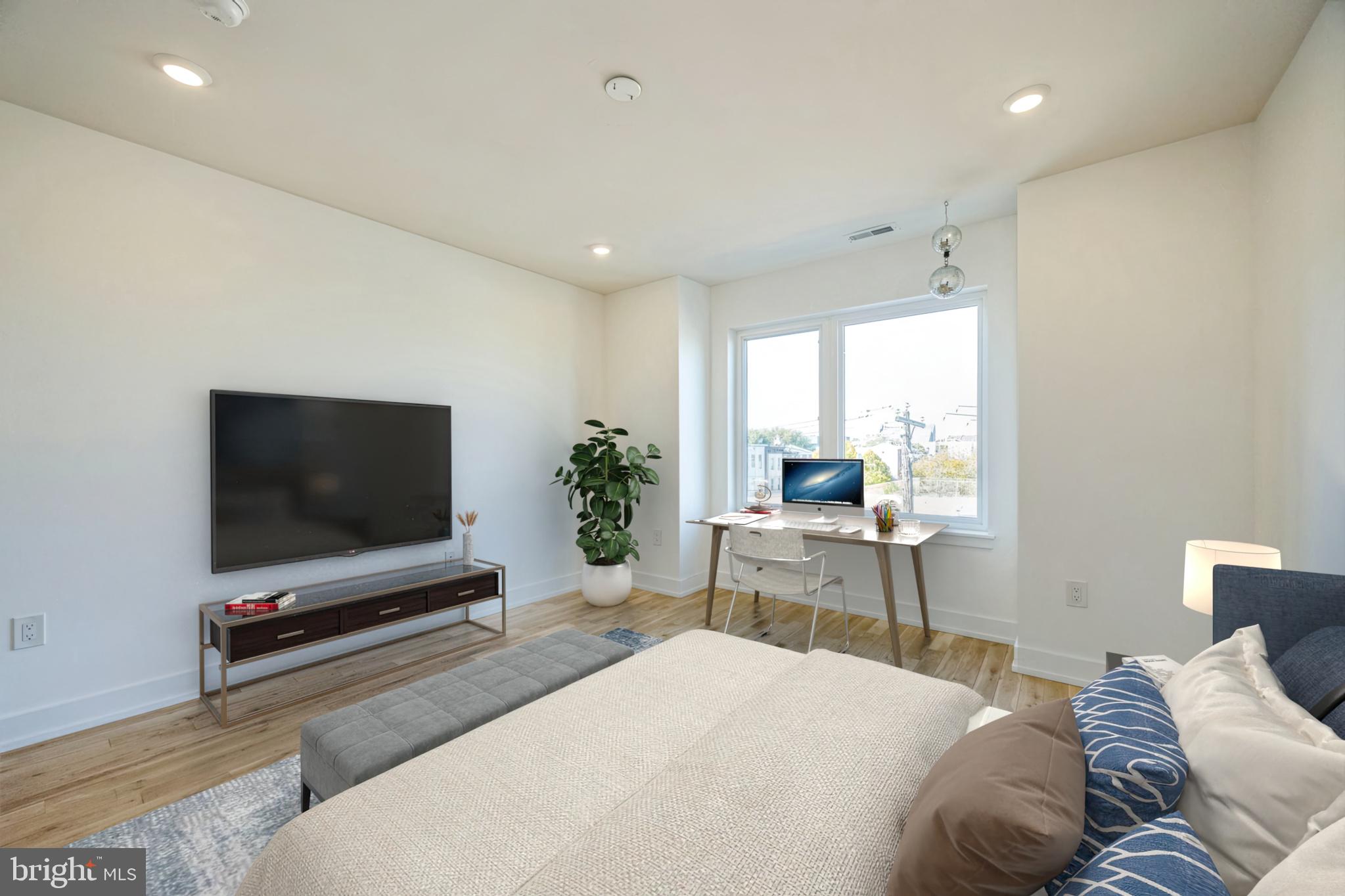 614 Master Street, Unit 2 Philadelphia, PA 19122 - Photo 24 of 29 a bedroom with a bed and a flat screen tv