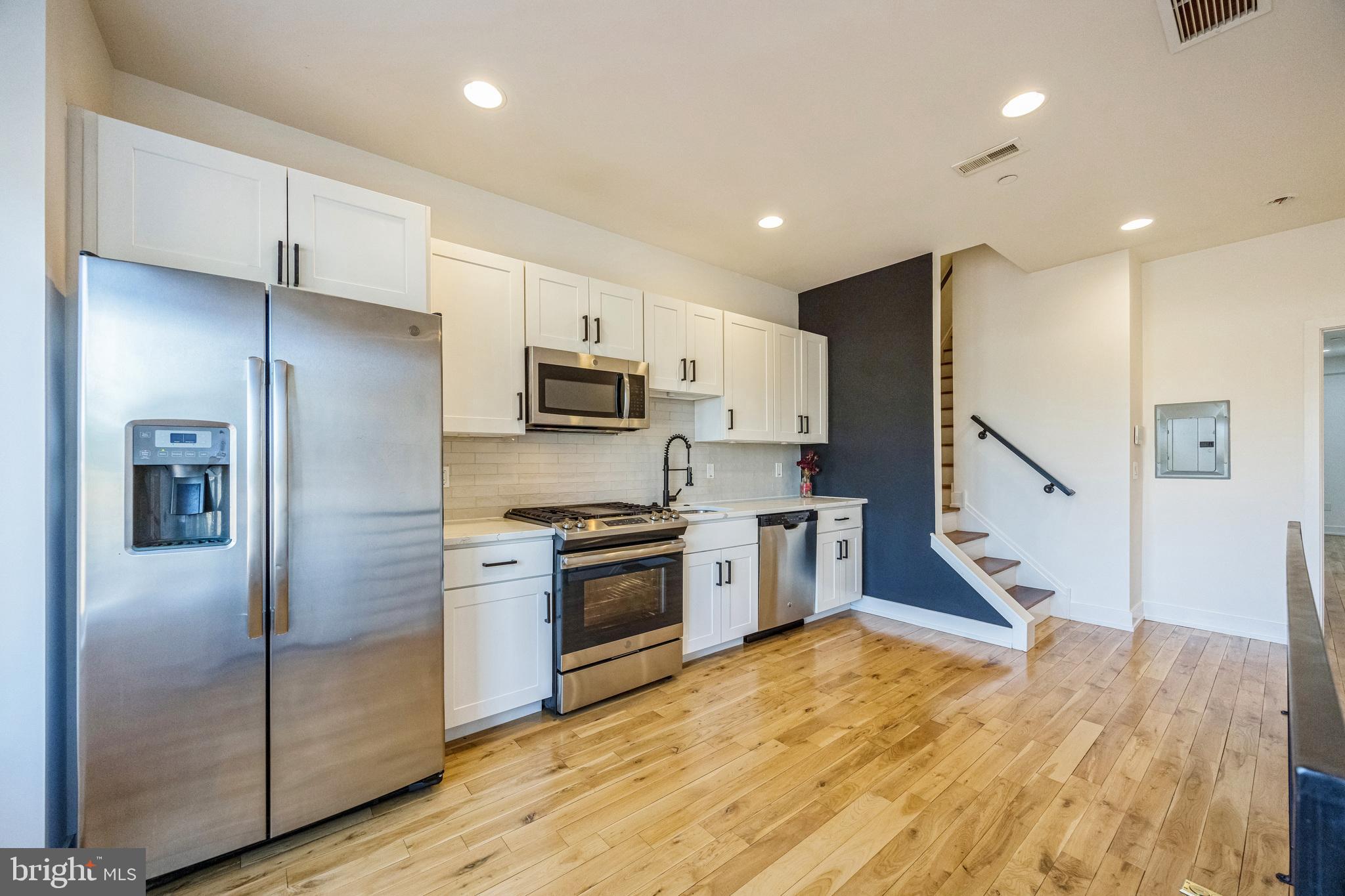 614 Master Street, Unit 2 Philadelphia, PA 19122 - Photo 3 of 29 a kitchen with stainless steel appliances granite countertop a refrigerator sink and microwave