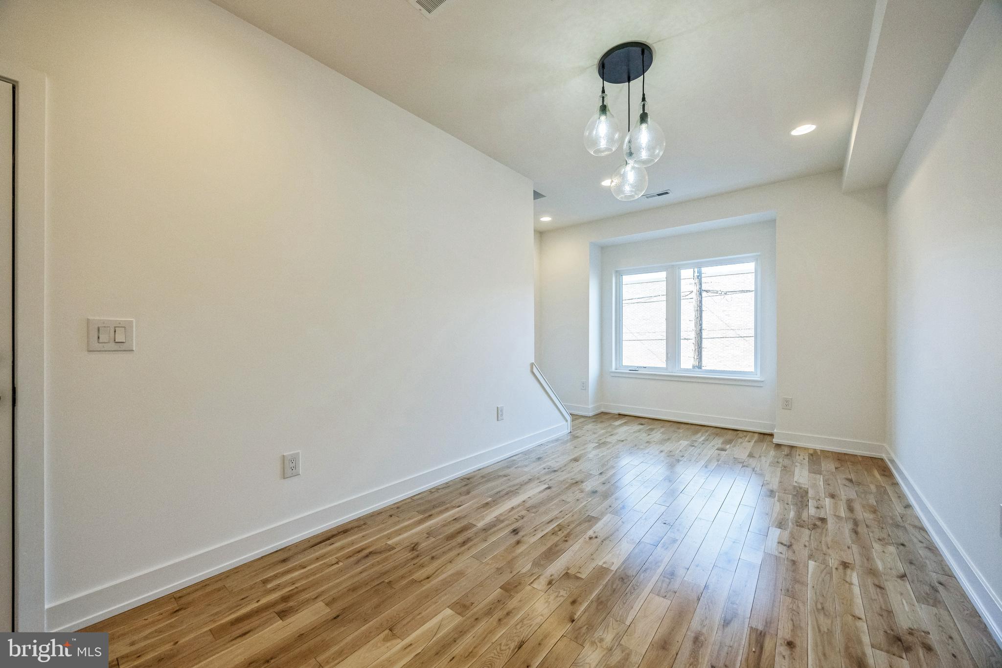 614 Master Street, Unit 2 Philadelphia, PA 19122 - Photo 6 of 29 wooden floor in an empty room with a window