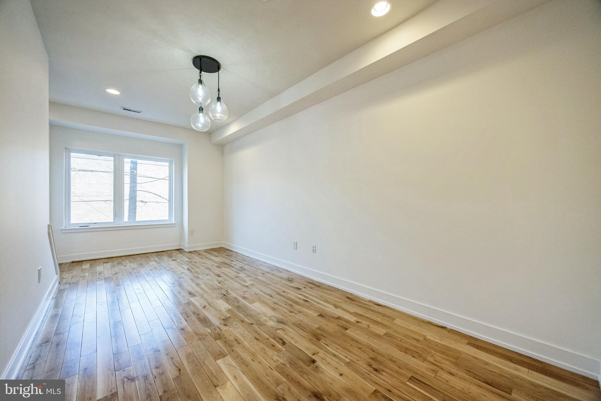 614 Master Street, Unit 2 Philadelphia, PA 19122 - Photo 9 of 29 wooden floor in an empty room with a window