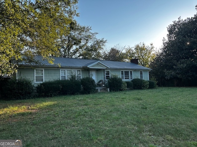5727 Henson Road Gainesville, GA 30506 - Photo 1 of 1 a view of a yard in front of a house with plants and large tree