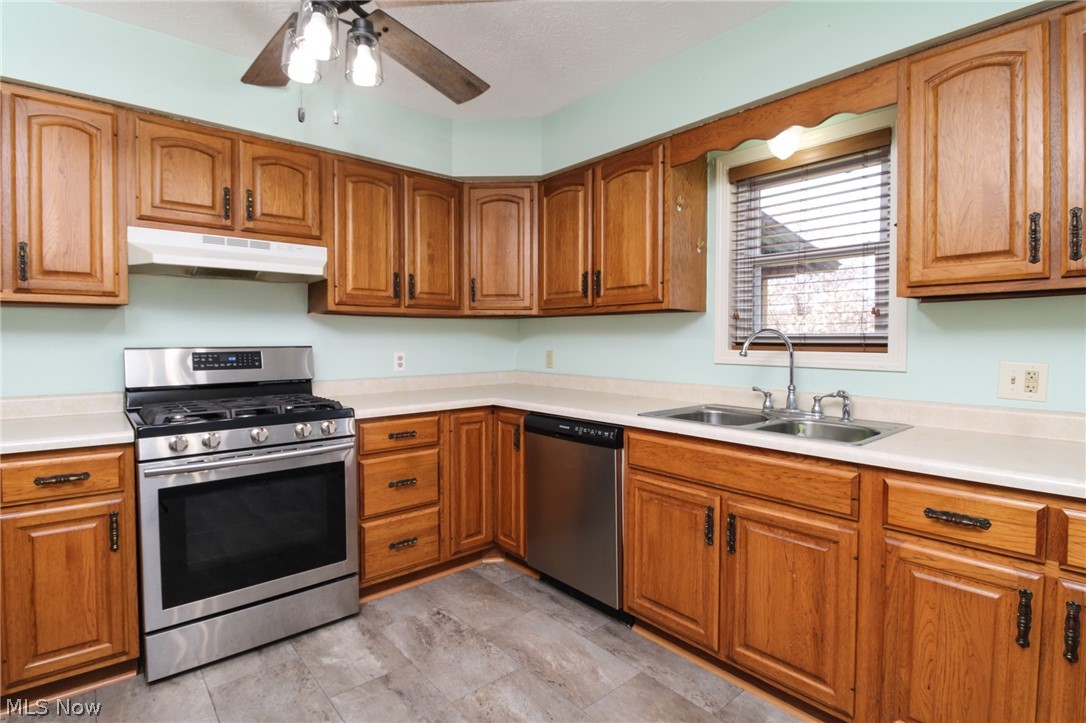 1502 Stone Quarry Road Fleming, OH 45729 - Photo 5 of 31 Kitchen with sink, stainless steel appliances, gas stove, ceiling fan, and light LVT floors