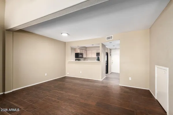 a view of a kitchen with a sink and a refrigerator